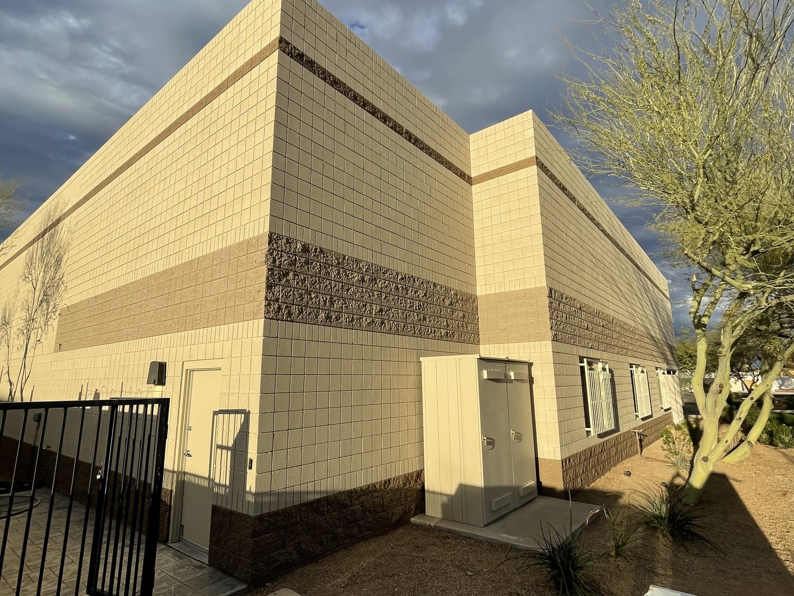 Commercial block building in Phoenix repainted in clean cream with brown banding