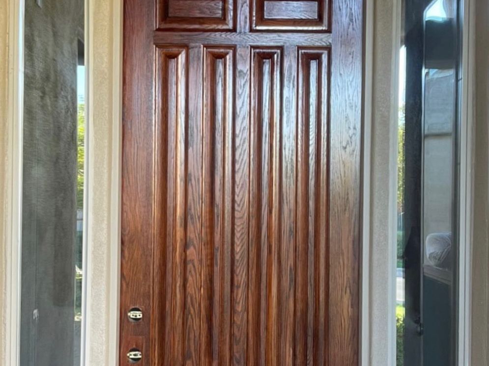 Phoenix entry door restored to a rich walnut finish with visible grain and sheen