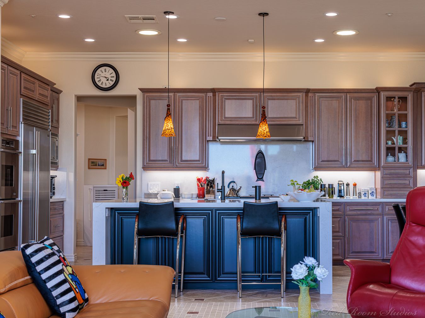 The same Phoenix kitchen finished, with warm stained cabinets and a navy island