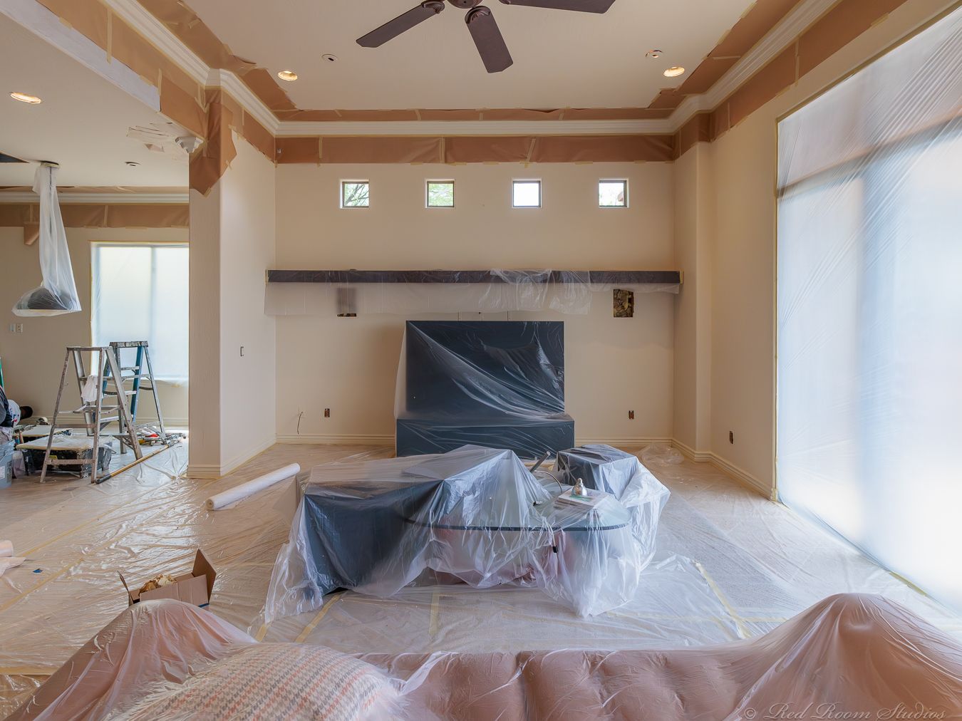 Phoenix living room fully masked with plastic sheeting over furniture before interior painting