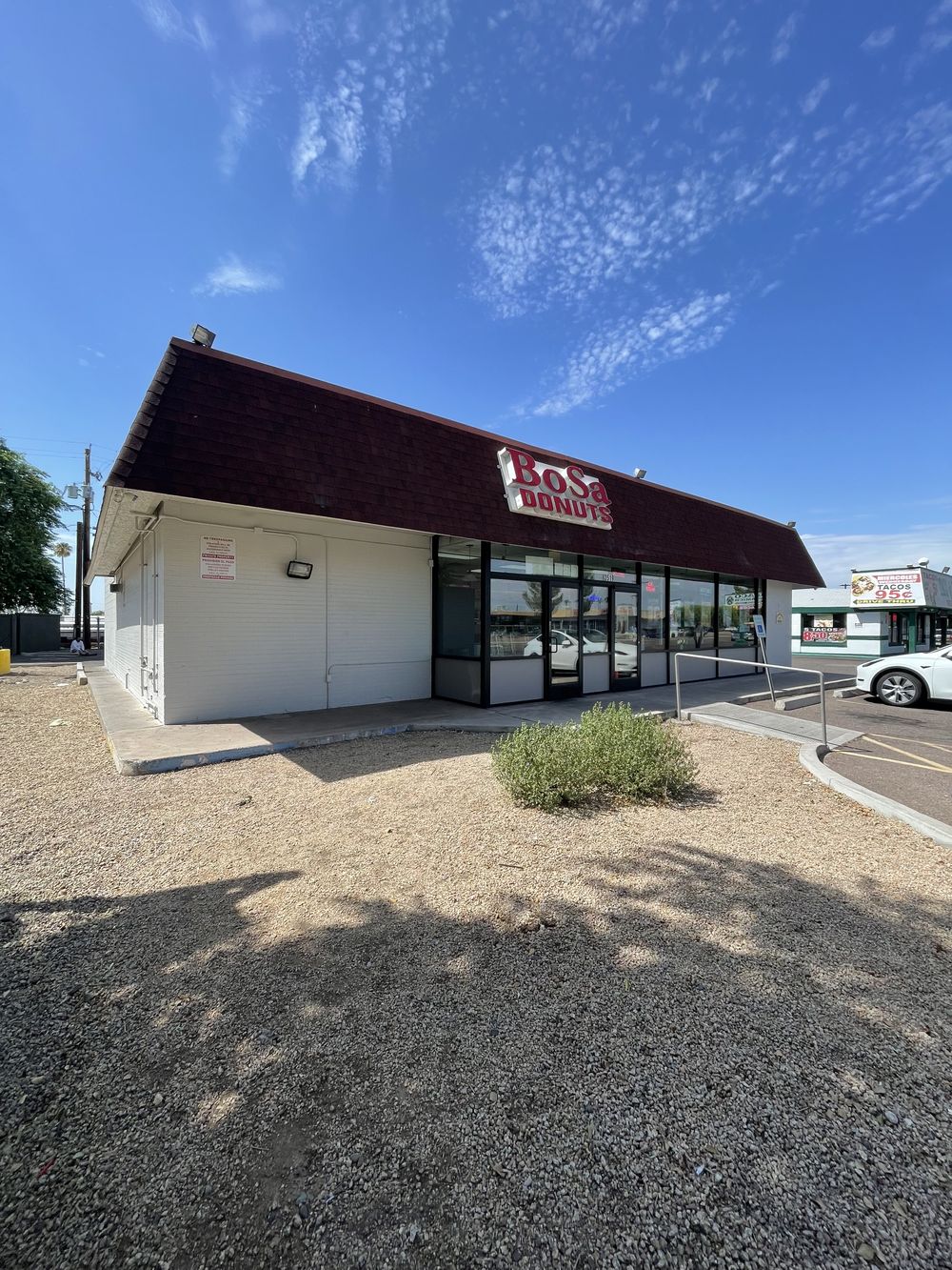 Phoenix retail storefront repainted with a deep red mansard roof and white block walls
