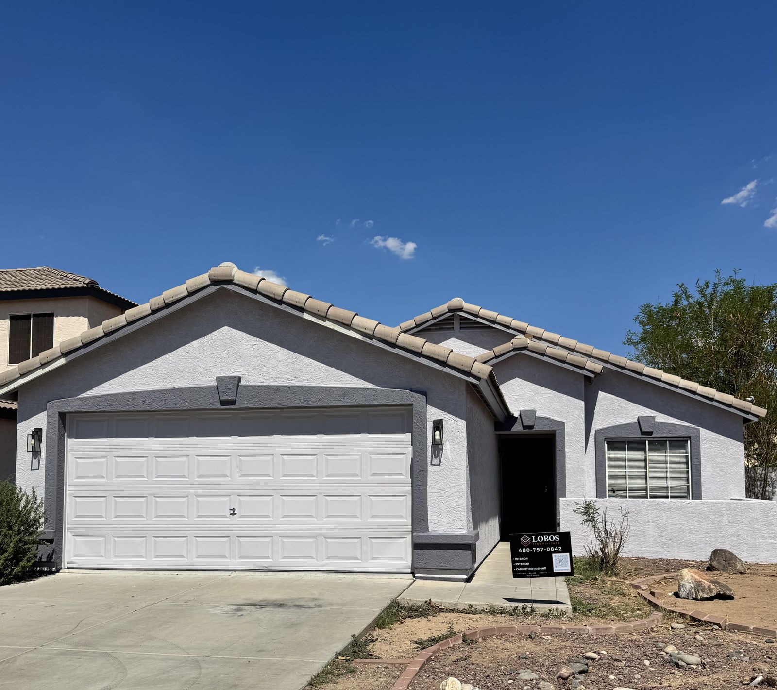 Single-storey Phoenix stucco home repainted in soft white with grey accents