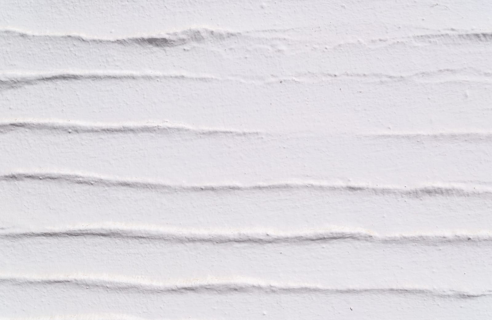 Limewashed wall showing crossing brush and trowel ridges