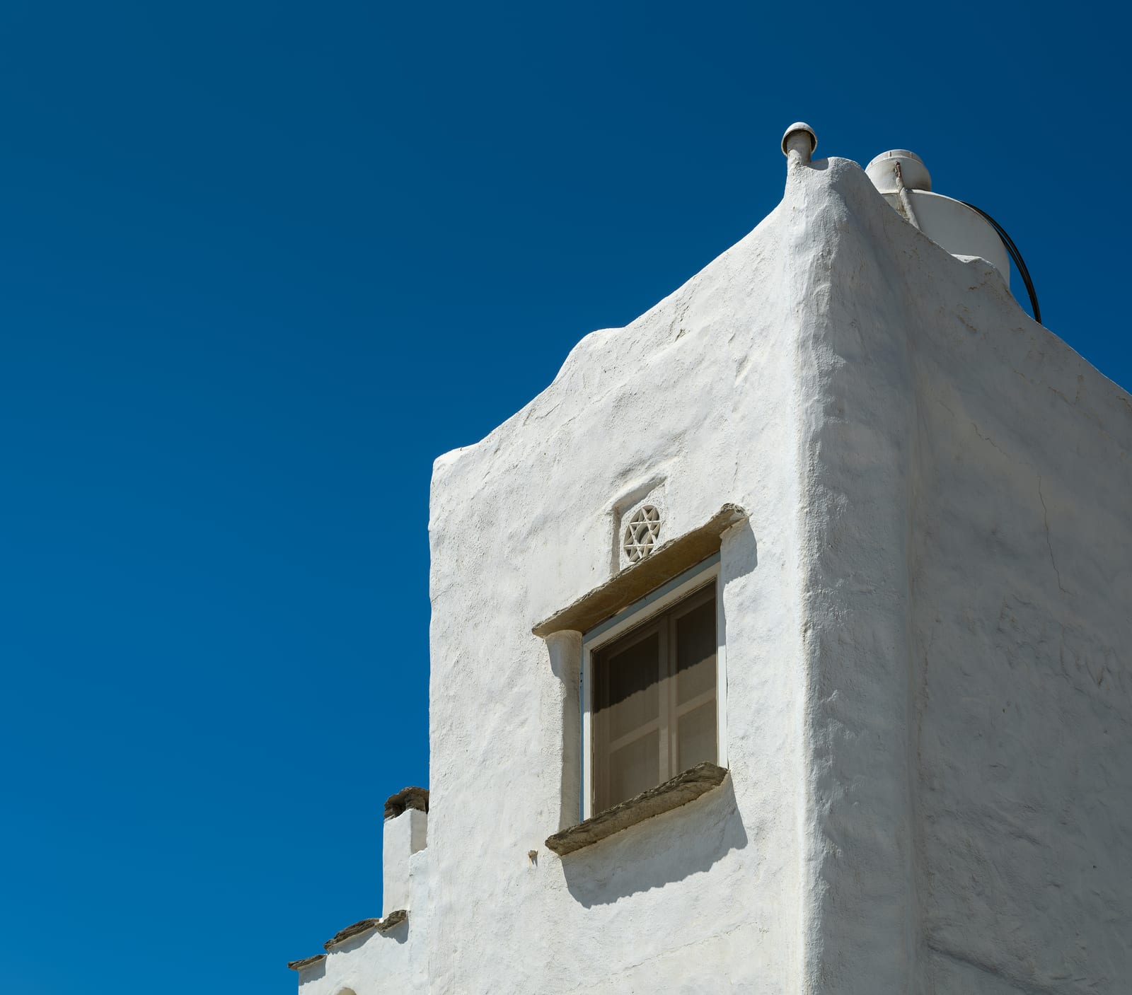 Limewashed masonry around a recessed window opening