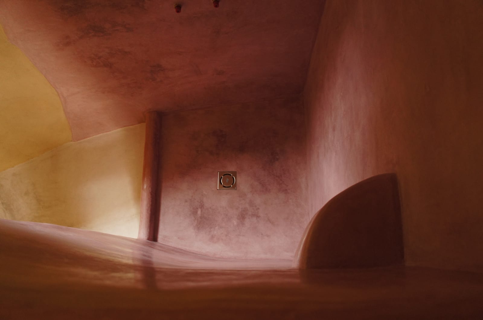 Terracotta lime plaster shower enclosure with curved returns